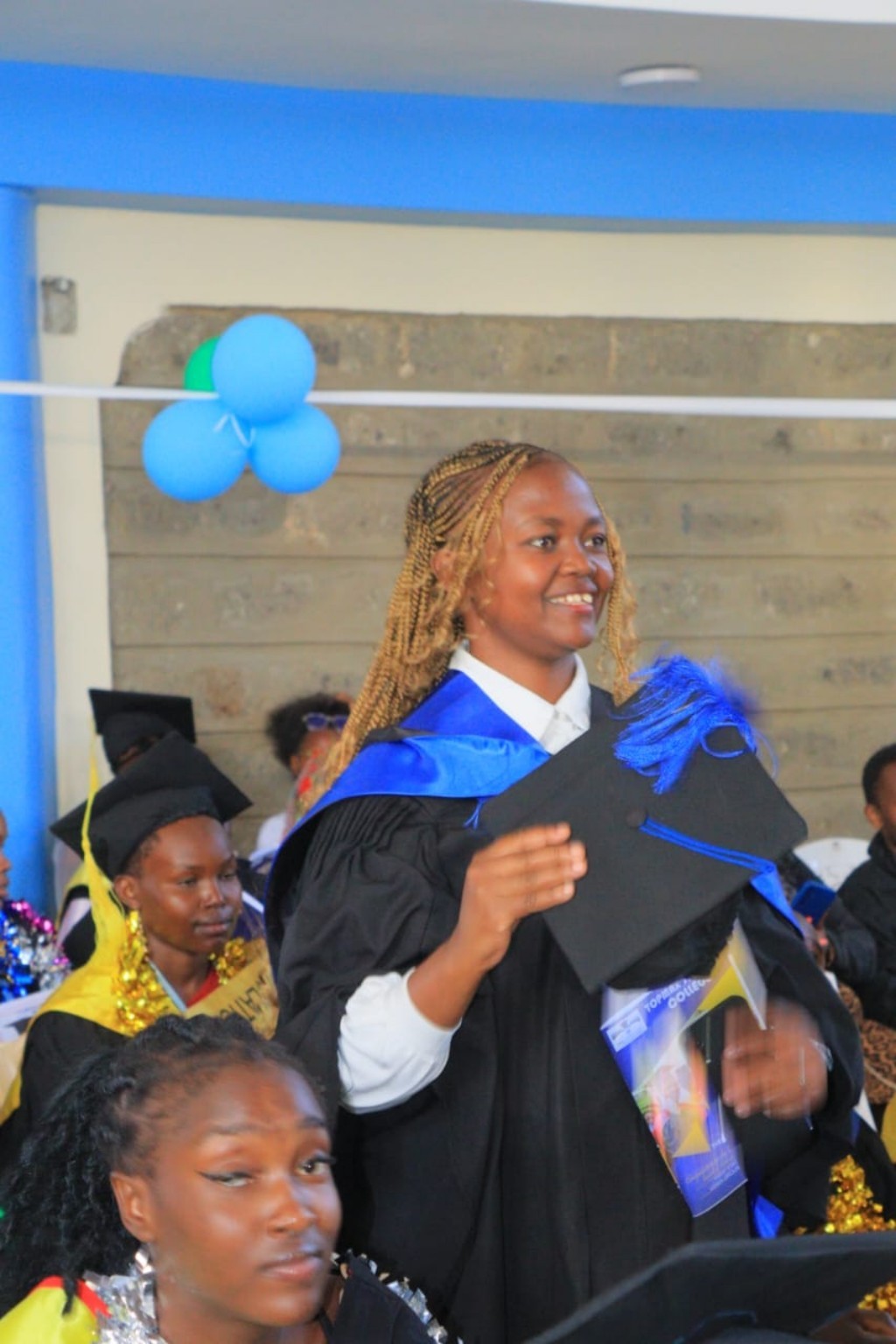 Topmax graduate celebrating her achievement
